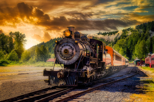 Historic Polson Logging No. 70 steam locomotive of the Mt. Rainier Scenic Railroad beneath a dramatic golden sunset near Mount Rainier in Washington.